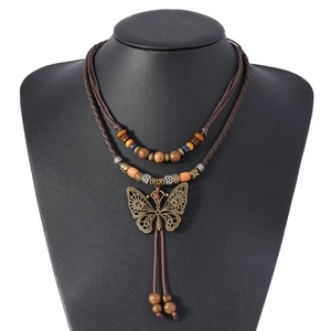 Retro ethnic layered necklace with hollow butterfly pendant and wooden beads on model