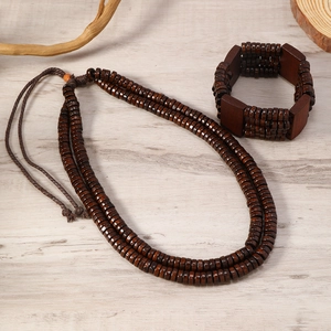 Bohemian multilayer brown wooden bead necklace and bracelet set on a natural wood surface