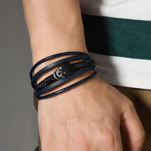 Men's punk leather wrap bracelet featuring a black metal skull and multilayered braided cords