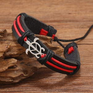 Detail of hand-woven leather bracelet with red cords and silver turtle charm