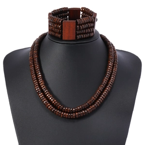 Bohemian dark brown wood bead necklace and multi-layer bracelet set on a black bust