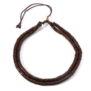 Detail view of Bohemian brown wooden beads and woven cord with adjustable clasp
