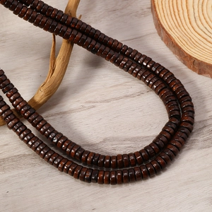 Macro detail of natural brown wood beads with polished texture on a vintage necklace