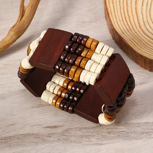 Detail of vintage wooden beaded wide bracelet with layered brown and cream textured beads