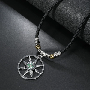 Detail of compass pendant with vintage metal frame and handmade beaded rope necklace