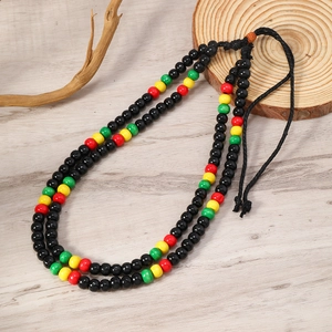 Detail shot of multi-layered wooden beaded necklace with red yellow green and black beads
