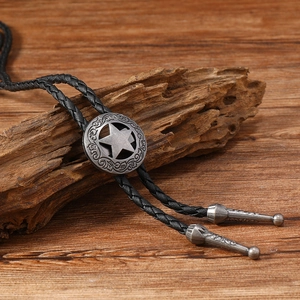 Vintage bolo tie with hollow star pattern and silver western floral engraving on wood