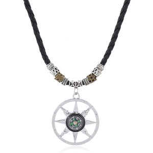 Close-up of retro compass pendant with alloy beads on adjustable black woven cord