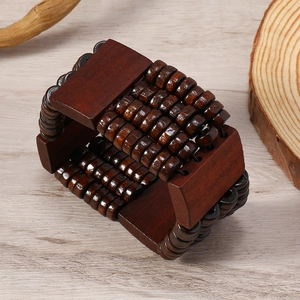 Bohemian brown wood bead bracelet with wide multi-layer design on natural wooden background