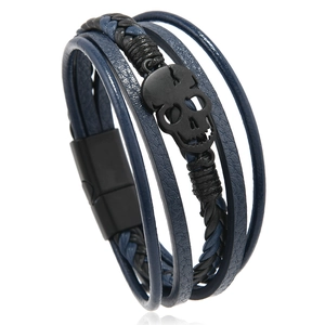 Close-up of punk style multilayer leather bracelet with black metal skull and magnetic clasp