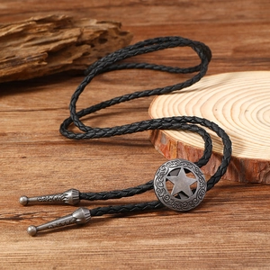 Detailed view of vintage western bolo tie with star engraved metal buckle and tips
