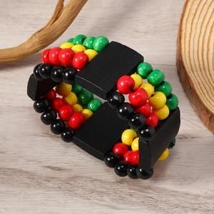 Detailed view of Rasta style multilayer wooden bead bracelet on a wood grain surface