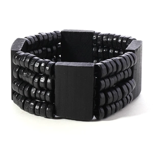 Detail of men's multilayer black wood bead elastic bracelet with ethnic wooden blocks