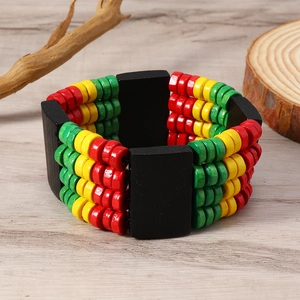 Detail of bohemian red yellow green wooden bead multi-row bracelet on a natural wood surface