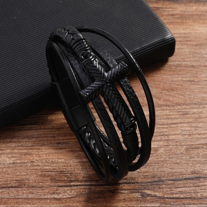 Detail view of multilayer black leather bracelet with cross charm and magnetic clasp
