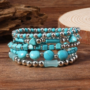 Bohemian multi-layer turquoise and silver beaded elastic bracelets on natural wood base