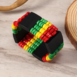 Macro shot of Bohemian wooden beaded bracelet with red yellow green Rastafarian colors