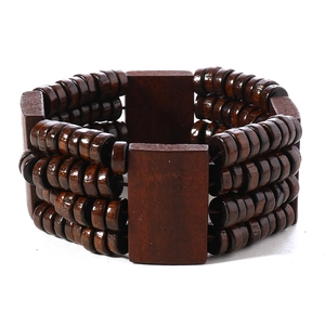 Close-up of Bohemian multilayered brown wooden bead bracelet with wide rectangular blocks