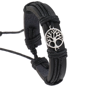 Close-up of multilayer black leather woven bracelet with silver Tree of Life pendant