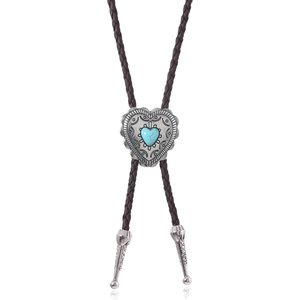Detailed view of western bolo tie with heart-shaped turquoise stone and vintage metal slider
