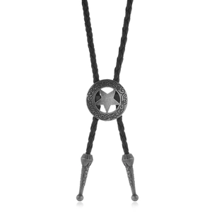 Macro shot of vintage silver bolo tie slide with pentagram carving and braided leather cord