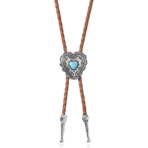 Detail of heart-shaped turquoise bolo tie with vintage silver-toned engraving