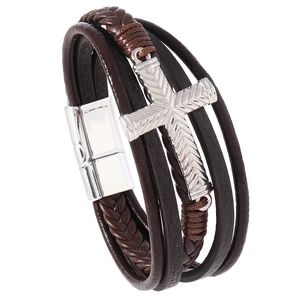 Detail of multi-layer leather bracelet for men featuring a silver cross and magnetic clasp