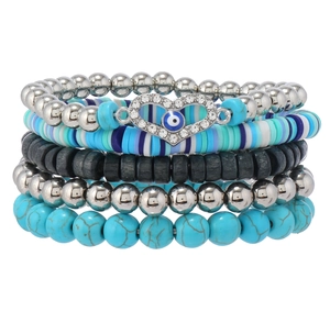 Detail of 5pcs layered beaded bracelets featuring turquoise, evil eye heart and wood beads
