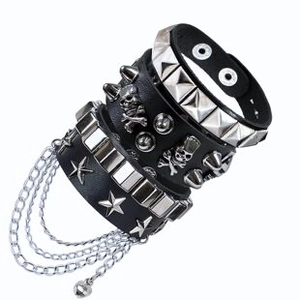 Close-up of punk rock leather bracelets with metal skull, studs and layered chains