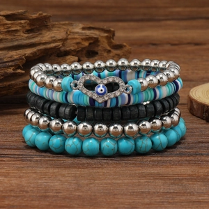 Detail view of five-piece multilayer beaded bracelet set with turquoise and evil eye charm