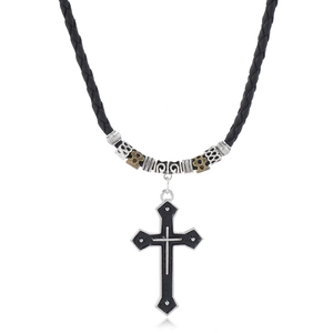Detail of men's beaded necklace featuring a large black cross pendant and woven cord