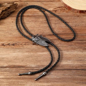 Macro detail of retro silver cicada bolo tie pendant on natural wood background