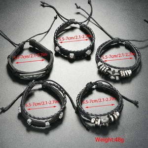 Detailed set of five adjustable punk leather bracelets with metal studs and skull charms