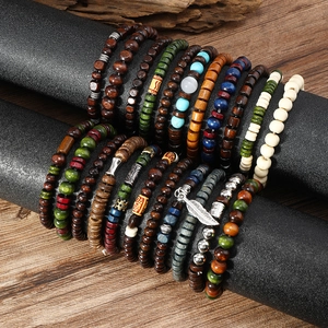 Detail of 22pc Bohemian wood bead bracelet set with turquoise and feather charms