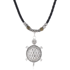 Macro detail of retro silver sea turtle pendant with intricate hexagonal shell patterns