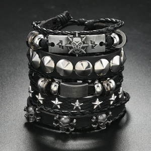 Detail showing layers of punk leather bracelets with silver skull and rivet charms