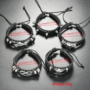 Detail of 5-piece punk leather bracelet set with skull, motorcycle and bull head charms