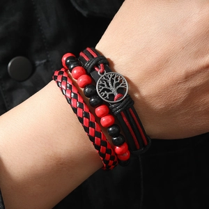 Detail of three-piece men's bracelet set with Tree of Life charm and woven red-black leather