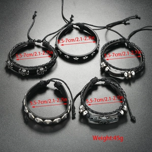 Detail shot of 5-piece punk bracelet set with leather, metal skulls, and silver rivets