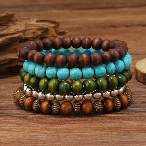 Detail of 5-piece multilayer turquoise and wood bead bracelet set on vintage wood