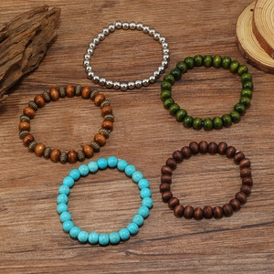Close-up of five-piece multilayer beaded bracelets with turquoise and wooden textures
