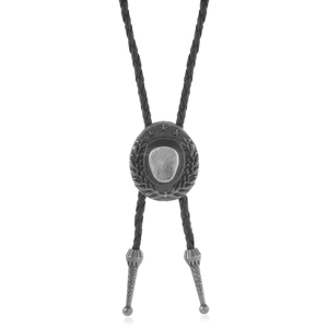 Detail of silver western bolo tie featuring embossed cowboy hat and star pendant