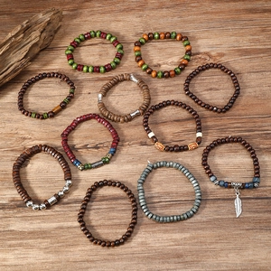 Detail view of 22-piece bohemian wood bead bracelets with turquoise and feather charms