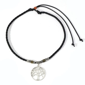 Adjustable black cord necklace featuring a silver tree of life pendant and carved metal beads