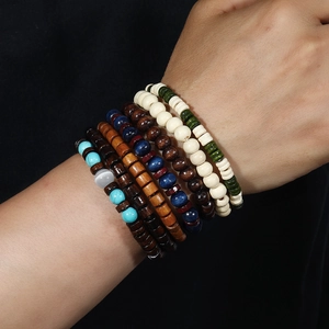 Close-up of Bohemian wood bead bracelet set with turquoise and opal beads on wrist