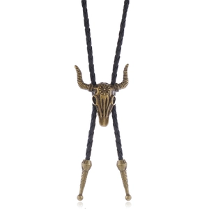 Macro view of vintage bronze bull head bolo tie pendant with star and braided leather cord
