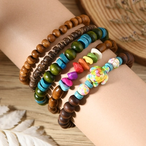 Detail of bohemian multilayer beaded bracelet set with turquoise stones and turtle charm
