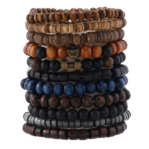 Detail view of 11-piece stacked bracelets with wooden beads and skull dumbbell charms
