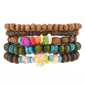 Detail of multi-layer turquoise beaded bracelet set with turtle charm and natural stones