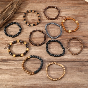 Detail of vintage wooden beads and cross charms on rustic brown wood surface